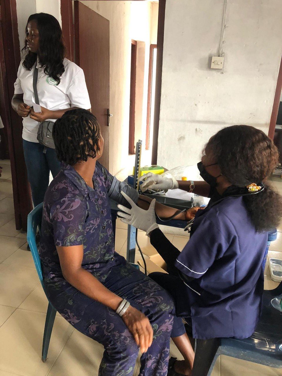 A volunteer checking a patient's blood pressure